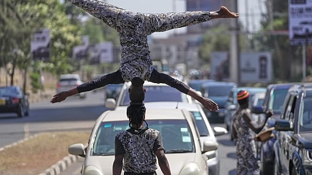 Street acrobats in Nairobi earn their livelihood by showcasing their talents to drivers.